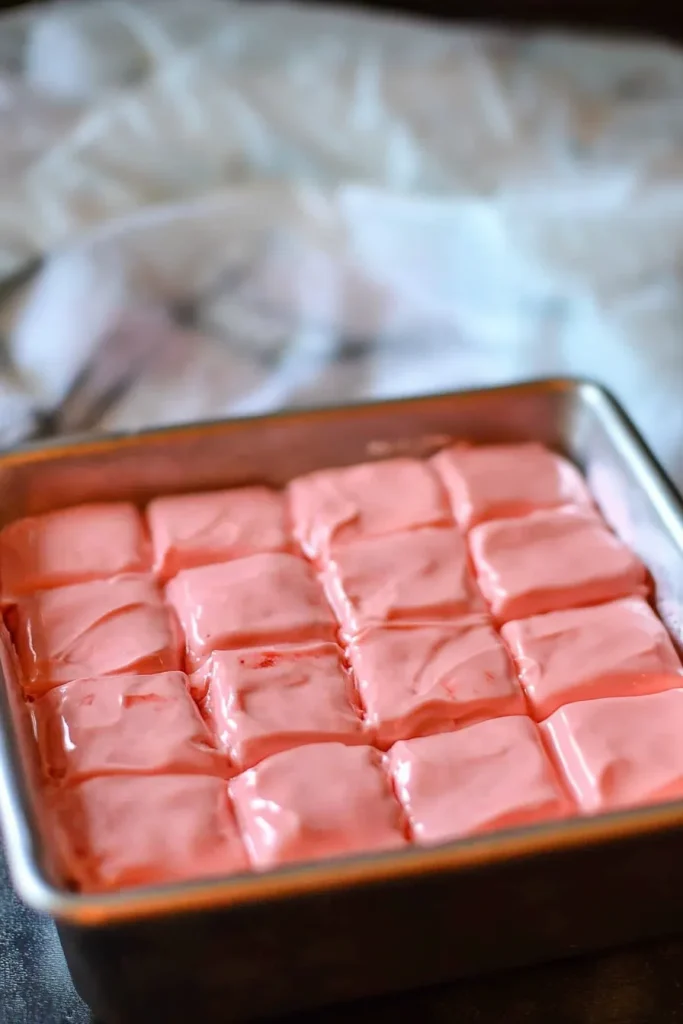 Uniform squares of sweet pink fudge lined up for serving.