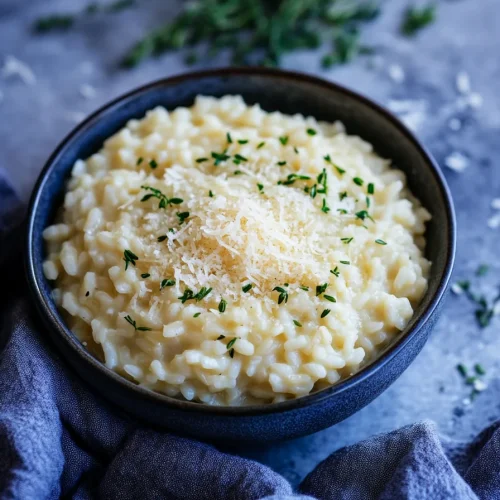 Classic Italian risotto served in a rustic bowl, garnished with parsley for color.