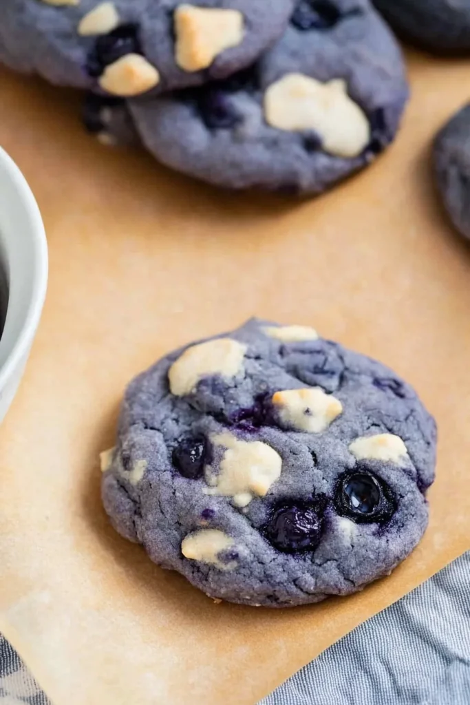 Close-up of vibrant blueberry cookies showing creamy white swirls.