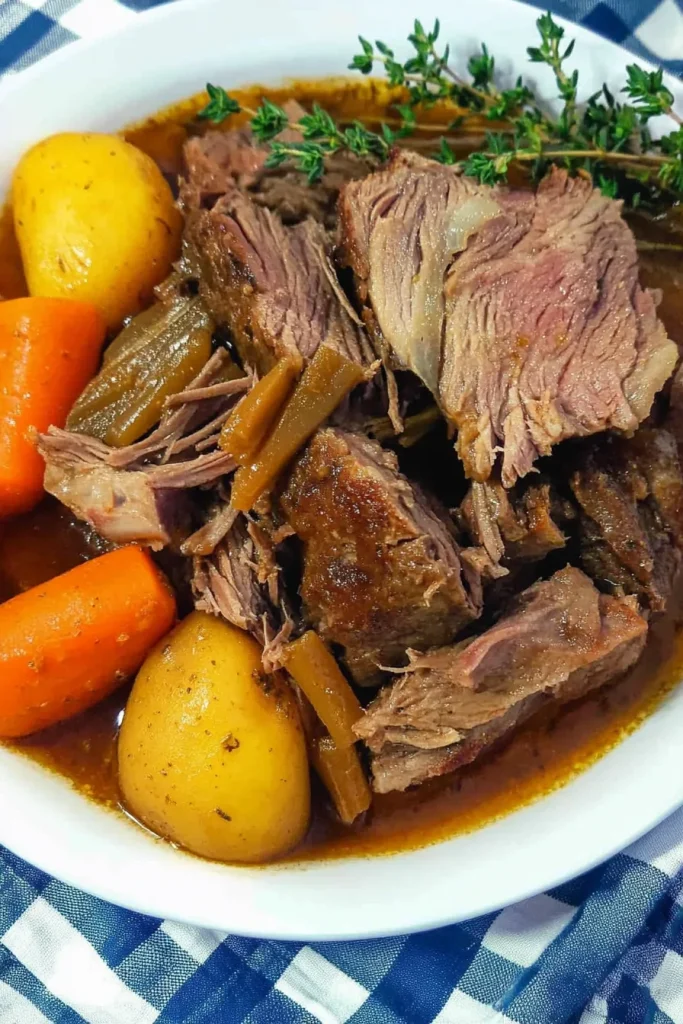 Classic roast dinner showing beef coated in savory brown sauce.