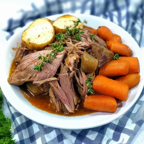 Tender shredded beef served with carrots and potatoes in rich gravy.