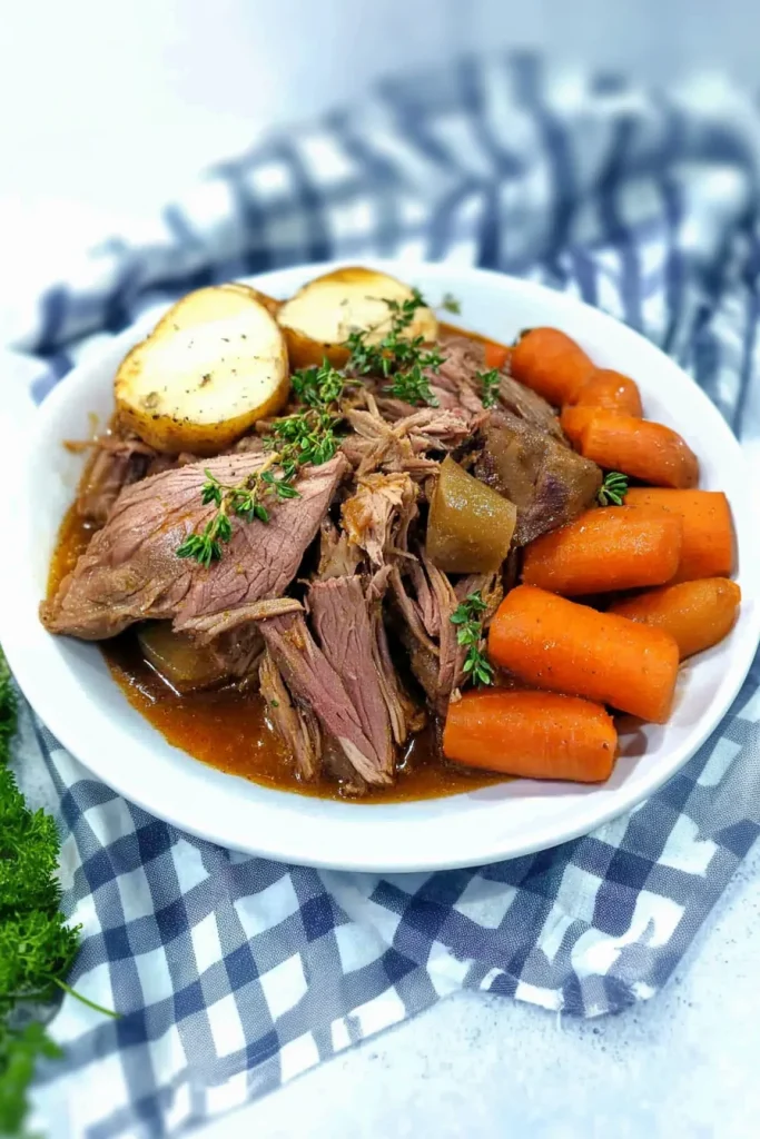 Tender shredded beef served with carrots and potatoes in rich gravy.