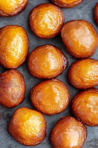Freshly made doughnuts with golden crust and glossy finish.