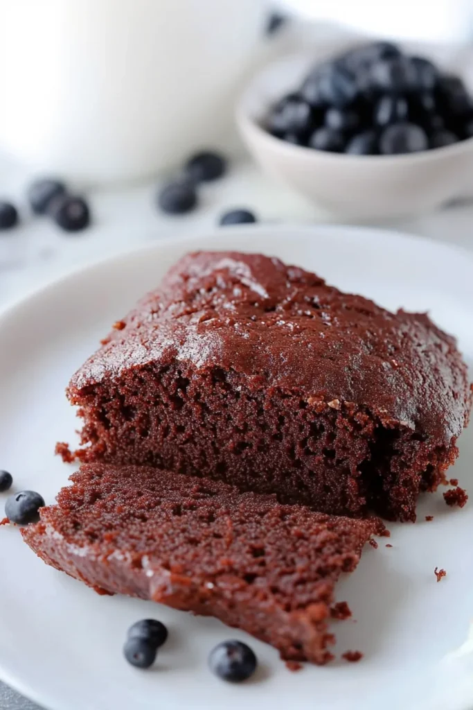 Dark chocolate cake paired with fresh blueberries for contrast.
