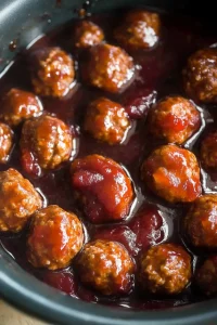 Overhead view of saucy meatballs arranged neatly in a bowl, ready to serve.