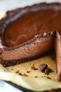 Close-up of creamy chocolate filling layered over dark crust.
