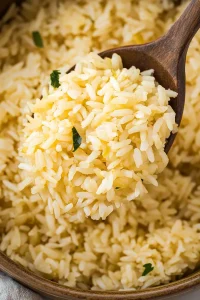 Steaming rice sprinkled with herbs, presented in a rustic dish