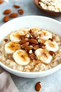 Nutritious breakfast showing creamy oats with fruit and crunchy toppings.