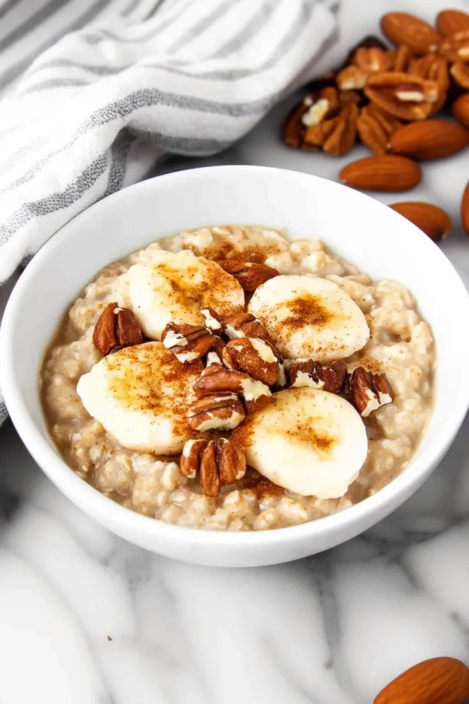 Overhead view of hearty oatmeal garnished with almonds and spice.