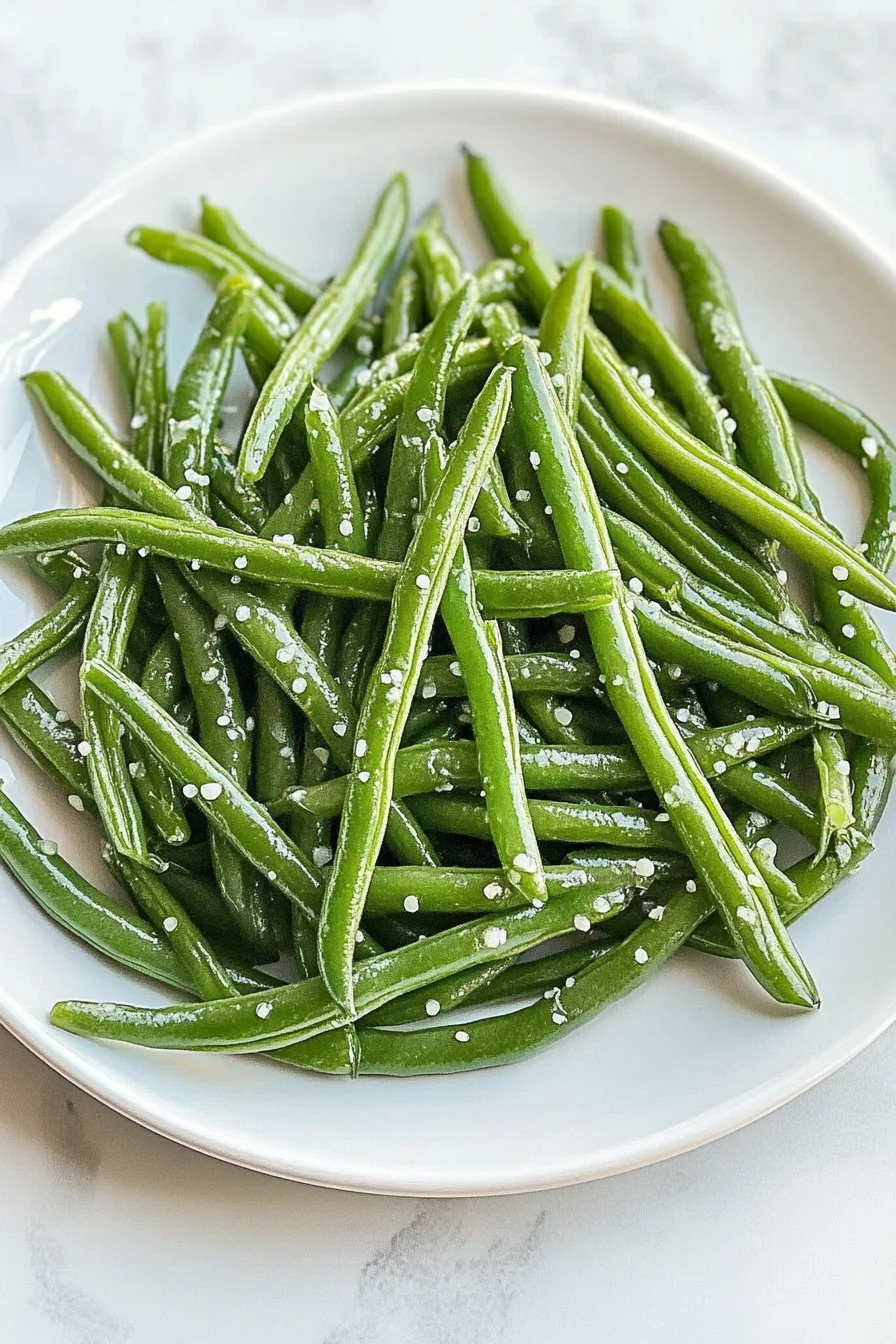 Close-up of tender beans, lightly coated with oil for shine.