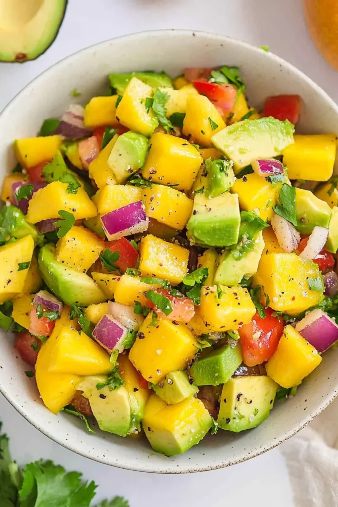 Bright summer salad with red onion and cilantro garnish.