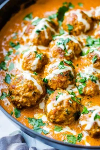 Rich tomato-based curry with meatballs simmering in creamy sauce