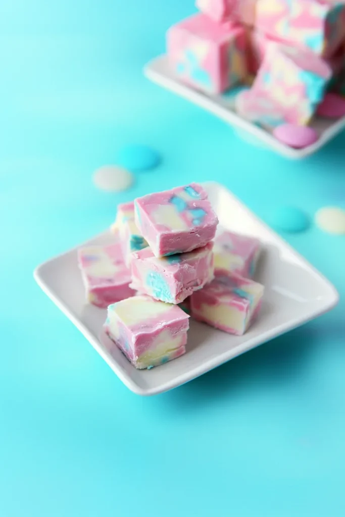 Overhead view of pastel fudge pieces arranged neatly, highlighting their swirled design.