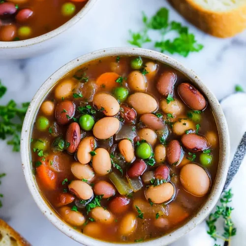 Warm, comforting bean soup served in a simple white bowl.