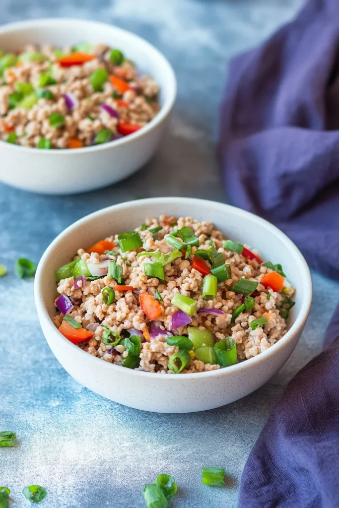 Bowl of stirโfried ground meat with cabbage, carrots, and onions.