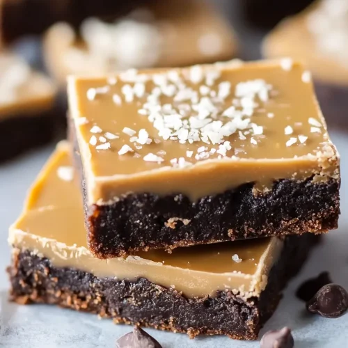 Close-up of layered bars showing rich chocolate bottom and smooth caramel frosting.